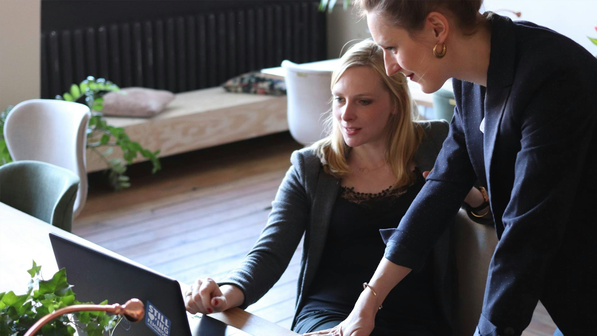 Two Women Looking at a Laptop
